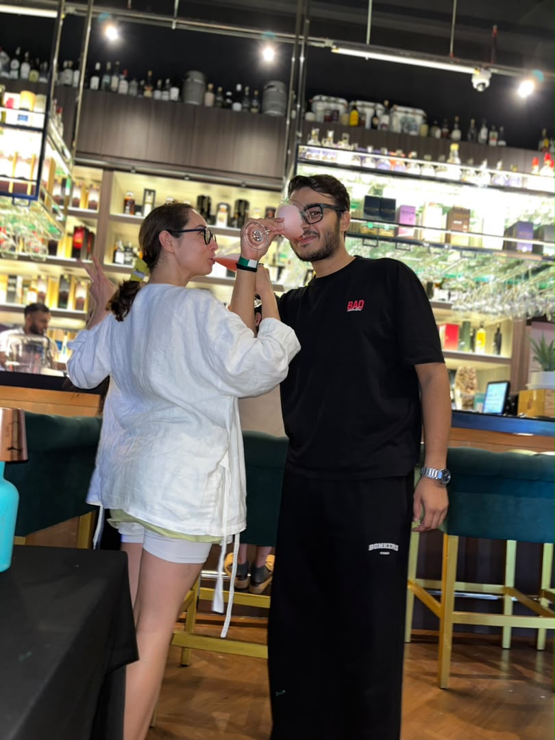 Two guests sharing a toast at the MÉSO bar